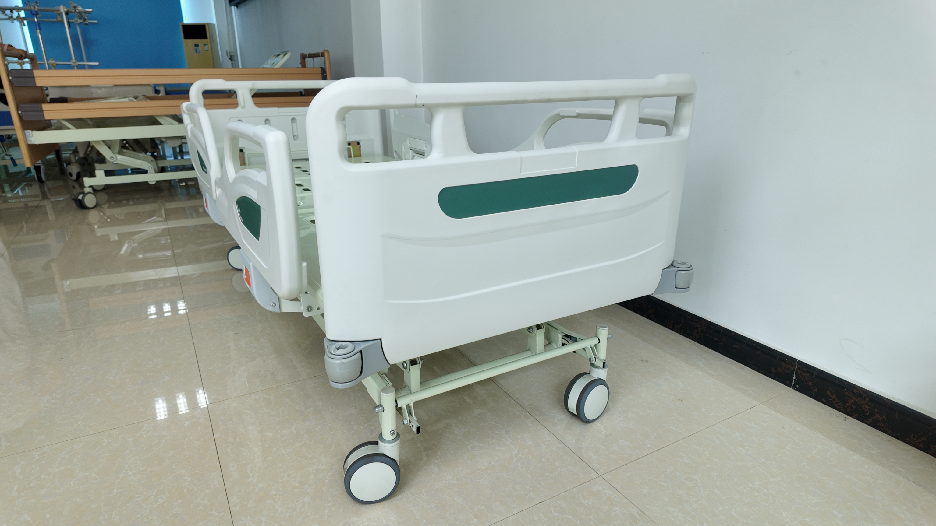 Picture of a three-function manual hospital bed with a green headboard